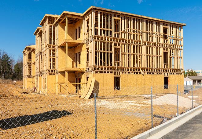 workers protected by temporary barrier fence during building maintenance in Lyford TX